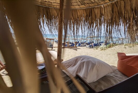 halikounas beach in corfu island greece summer tourist resort with long sandy beach umbrellas and bar