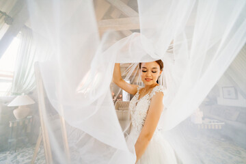 portrait of a beautiful and gentle bride with a long veil. femininity and beauty