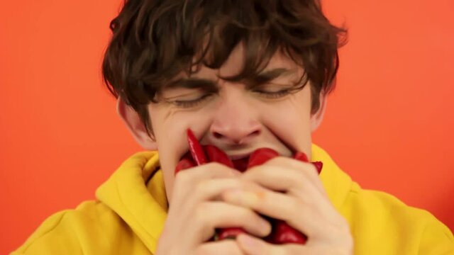 Man eating hot chili peppers.