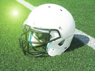 American Football helmet on field with yard lines