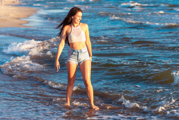 Young woman playing in the sea.woman enjoying in sea water .Cheerful young woman having fun on the summer beach.