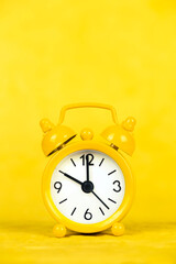 Yellow clock vertical background, save time or daylight savings concept