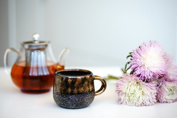 still life with teapot, cup and flowers