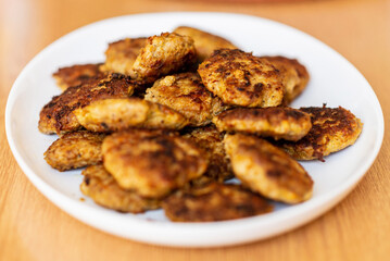 Homemade cutlets,meatballs white plate on a table yellow background.Delicious homemade cutlets.Selective focus.