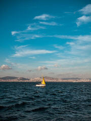 The yacht sails on the waves against the background of Istanbul
