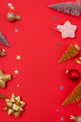 Christmas Background with Gold and Silver Small Christmas Tree Golden Confetti Christmas Balls Holiday Festive Seasonal Background Red Background Vertical