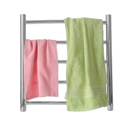 Modern heated towel rail with warm soft towels isolated on white