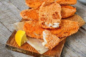 Fish and chips.Crispy  breaded  fish fillets  and French  fries  on woodn background 