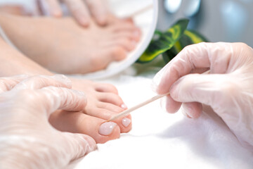 therapeutic pedicure with a stick for nails.