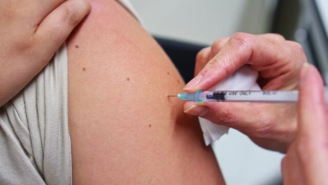 Doctor doing Covid 19 virus vaccine injection 