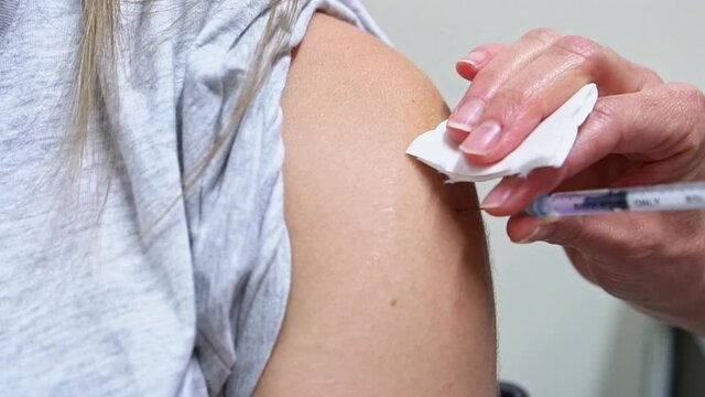 Doctor doing Covid 19 virus vaccine injection 