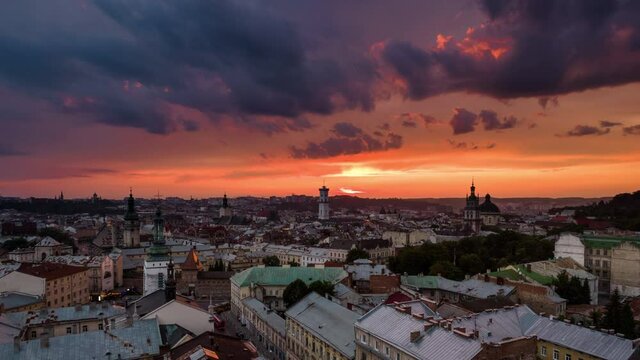 Aerial hyper lapse flying above cityscape skyline in Lviv, Ukraine at sunset. Time lapse of busy urban city life concept