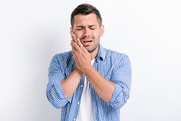 Dental problems. Portrait of unhealthy man pressing sore cheek, suffering acute toothache,...