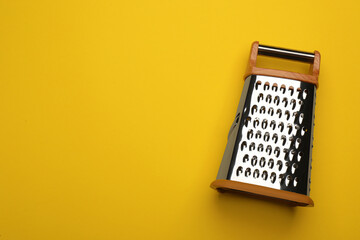Fototapeta na wymiar Modern grater on yellow background, top view. Space for text
