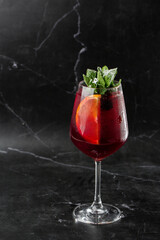 Closeup glass of red wine fresh sangria at bright bar counter background.