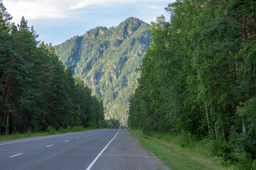Mountain peaks and asphalt highway. Russia, mountain Altai