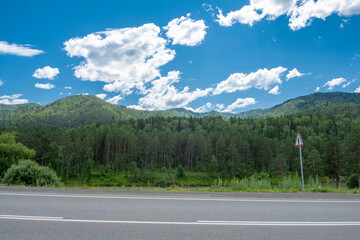 Mountain peaks and asphalt highway. Russia, mountain Altai