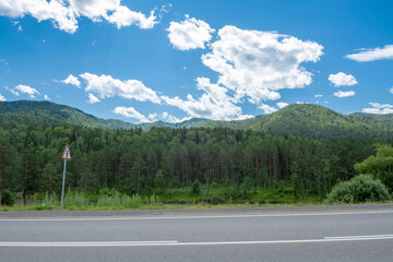 Mountain peaks and asphalt highway. Russia, mountain Altai
