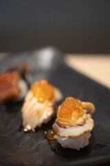 Selective focus of sushi with salmon roe on top
