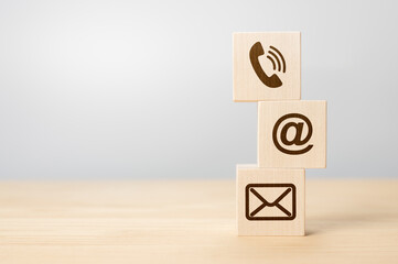 Contact us concept, Wood block symbol telephone, mail, and address on desk. Close-up Of Various...