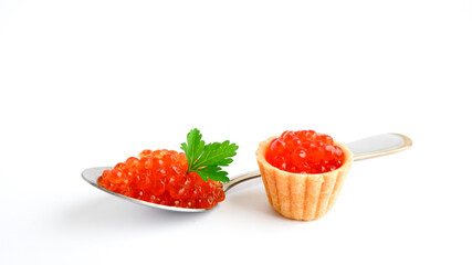 Tartlet with red caviar and spoon with green parsley leaf on top isolated on white background. 