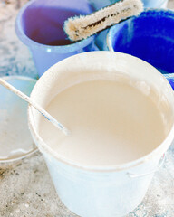 The concept of repair of the house and premises. Buckets of paint and lime for whitewashing and painting walls. A real non-staged scene while working.