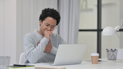 Fototapeta premium African Woman Coughing while using Laptop at Work 