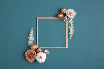 Still life of gold and white elements with a frame for text on a turquoise background. Minimalistic...