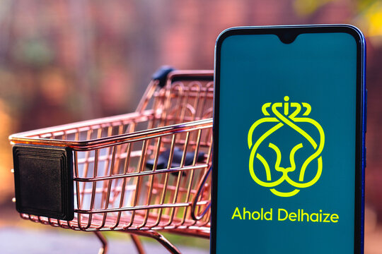 September 2, 2021, Brazil. In this photo illustration the Ahold Delhaize logo displayed on a smartphone along with a shopping cart.