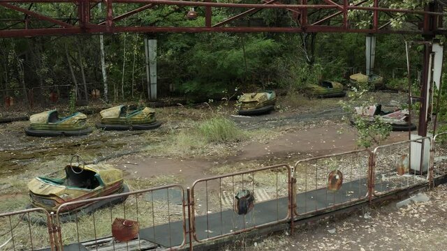 Drone view of an abandoned amusement park in Pripyat ghost town, Exclusion zone of Chernobyl, Ukraine. Rusty bumper cars in Chornobyl autodrome