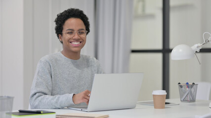 Fototapeta premium African Woman with Laptop Smiling at Camera 