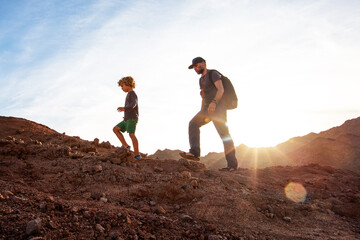 Dad with son in the mountains in the desert - 454582438