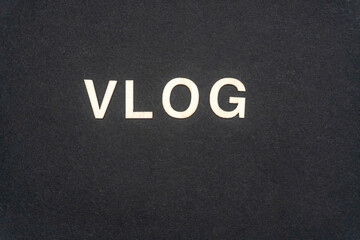 VLOG word written on dark paper background. VLOG text for your concepts