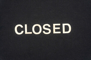 CLOSED word written on dark paper background. CLOSED text for your concepts