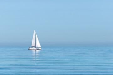 Sailing boat on sea against clear sky