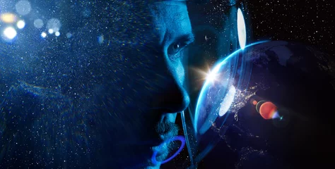 Planet Earth from space at night. Elements of this image furnished by NASA. Double exposure portrait of astronaut in spacesuit. Astronomy conception. Distant galaxies and deep space. © KDdesignphoto