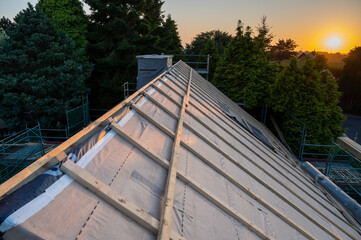 Old house gets a new roof . Picture taken at sunset.