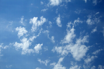 Naklejka na ściany i meble Beautiful white clouds against the blue sky, copy space. Blue sky with clouds, free space. Clouds transition with a gradient. Texture. The background.