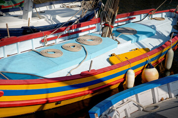 Details of the hull of old fishing boats with coiled ropes
