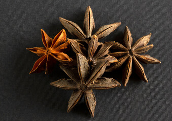 Star anise on black background.