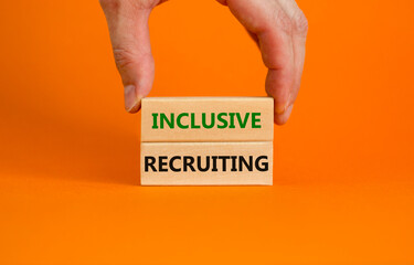 Inclusive recruiting symbol. Wooden blocks with words Inclusive recruiting on beautiful orange background. Businessman hand. Business, HR and inclusive recruiting concept. Copy space.