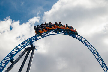 Ride roller coaster in motion in amusement park