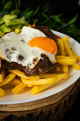 Typical portuguese dish, nail on the plate (grilled beef steak), with french fries and salad.