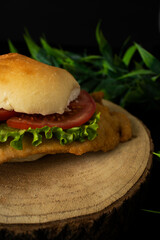 Chicken breaded sandwich with lettuce and tomato.