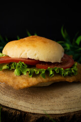 Chicken breaded sandwich with lettuce and tomato.