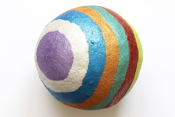Wooden ball painted in multi-colored stripes. Multi-colored ball. 