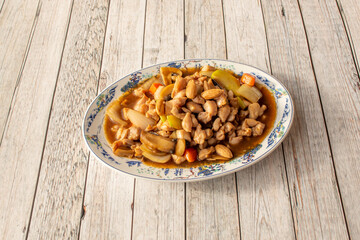 Tray of chicken with almonds, mushrooms and vegetables sautéed in wok cooked with Chinese recipe and soy sauce