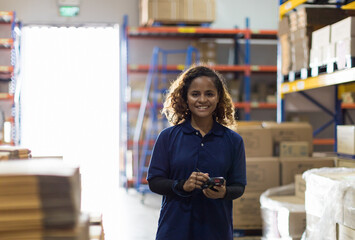 Portrait of warehouse female worker in the warehouse storage with happy and smile. Inspection...