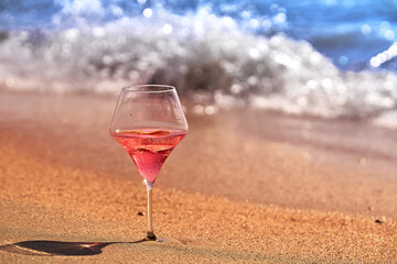 Wine glass with a cocktail by the sea.