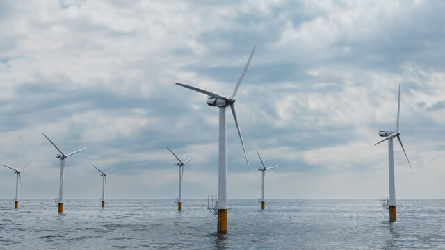 Wind Turbines. Offshore Wind Farm on a Cloudy Afternoon. Renewable Power Concept.